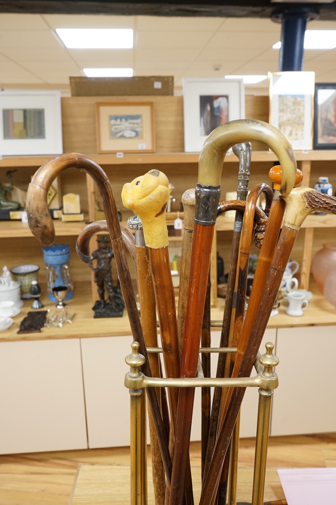 A collection of various walking sticks, some silver mounted and a brass stick stand, 67cm high